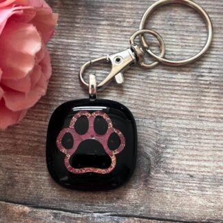 Dog paw print keyring handmade with fused glass - a copper pawprint outline on black glass