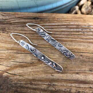 Long, narrow, textured fused silver drop earrings with sterling silver ear wires