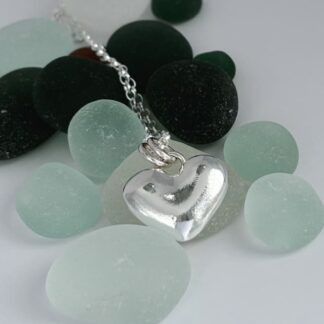 A heart made from fine silver with sterling silver bail and chain