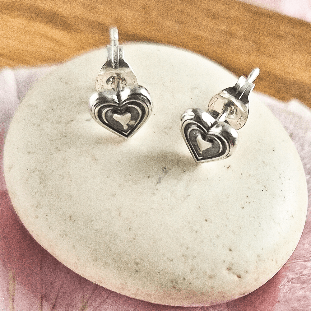 Style A involves silver stud earrings of concentric hearts.