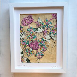 framed textile art of a lace cap hydrangea showing a large pink bloom and leaves