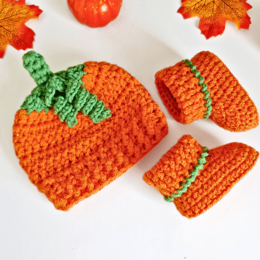Handmade crochet pumpkin baby hat with curly green stalk and matching booties, autumn and Halloween gift for newborn to 6 months