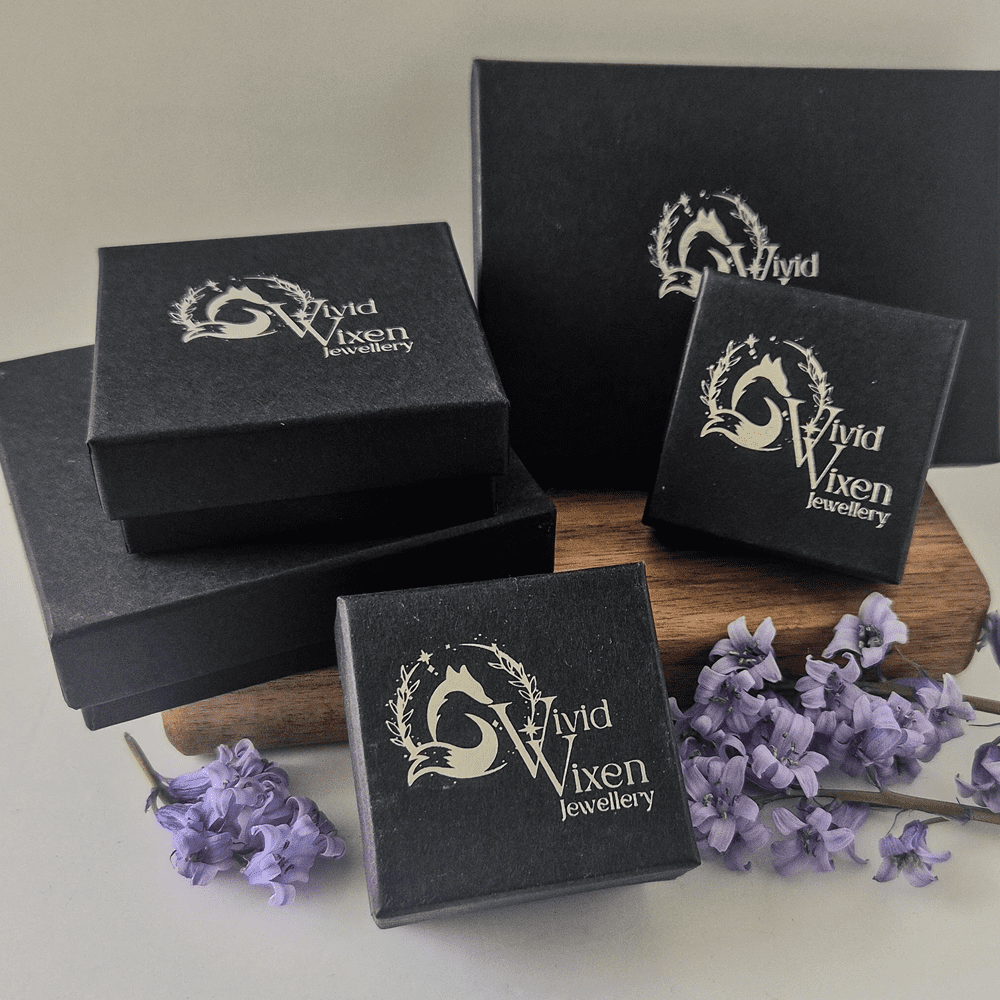 Five black Vivid Vixen Jewellery boxes with the fox logo in silver foil on the top.