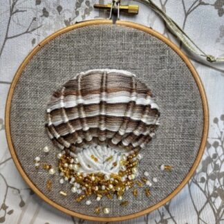 5" embroidery hoop with a Shell in shades of brown and cream embroidery