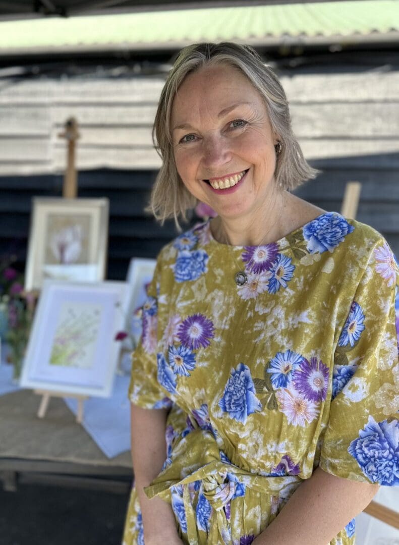 Photograph of Lisa Reeve in floral dress smiling
