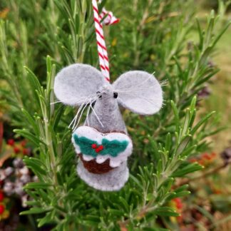 a-handmade-felt-mouse-holding-a-heart-shaped-Christmas-pudding
