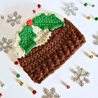 Handmade crochet Christmas pudding baby hat in cream and walnut brown with holly and berry detail.