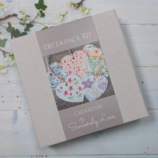 A white box wuth a grey label showing some decoupaged hearts.