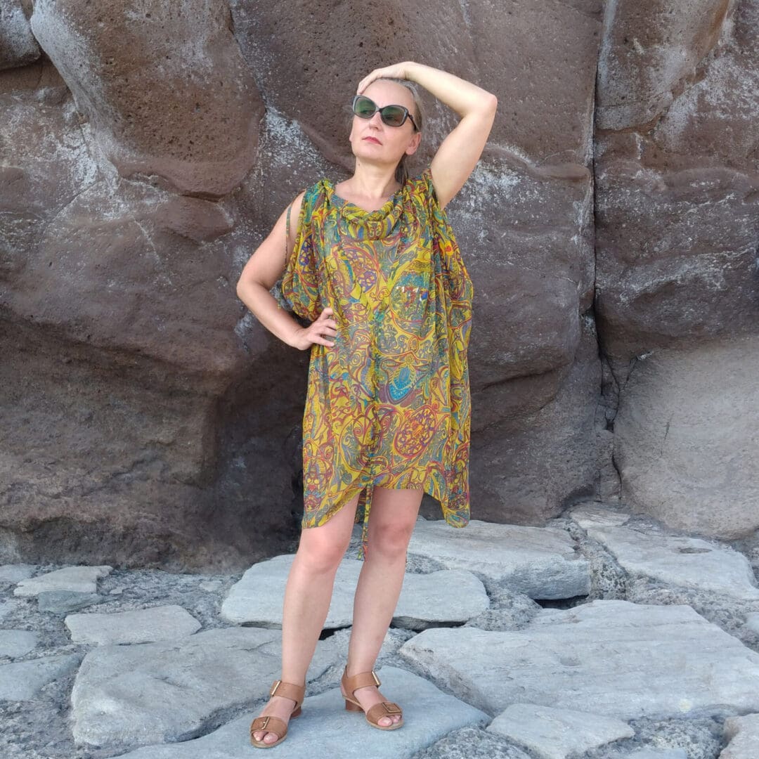 woman wearing draped grecian style beach dress