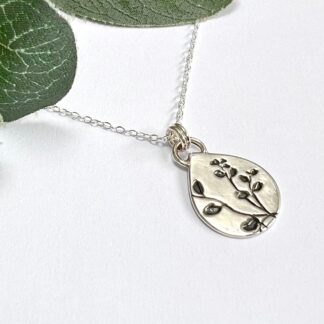 Handmade silver teardrop shape necklace with botanical pattern