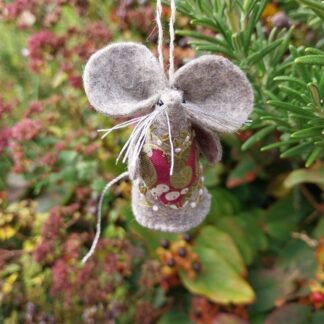 a hand crafted felt mouse, with a fabric applique heart tummy and hand embroidery