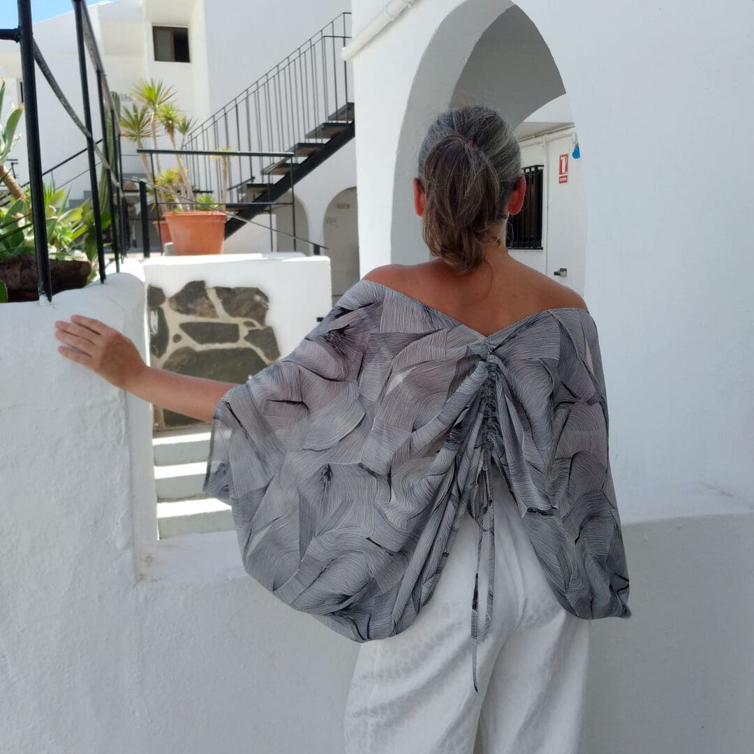 woman wearing loose kaftan top with drawstring and back