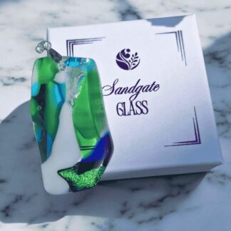 Large statement glass necklace featuring ocean-inspired colours and a silver-plated bail.