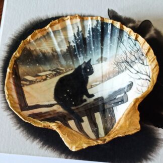 Handcrafted decoupaged scallop shell trinket dish featuring a black cat against a snowy winter landscape. The design is in a Japanese style featuring Japanese architecture in the background. The shell has been lacquered to a high shine and the edges and reverse gilded in a rich gold paint.