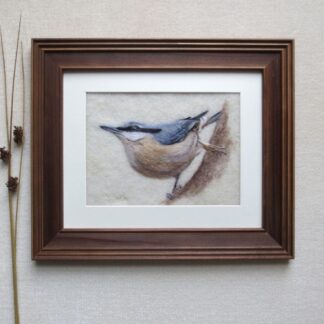 Side profile of a nuthatch bird clinging downwards to the bark of a tree trunk.