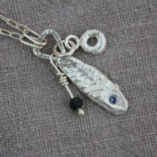 fishy theme cluster necklace with cuttlefish cast fishy, reticulated hoop charm and ruby zoisite bead