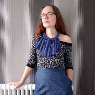 woman dressed in off-shoulder top and chunky bib necklace