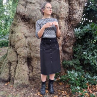 woman dressed in button down skirt and boat neck top