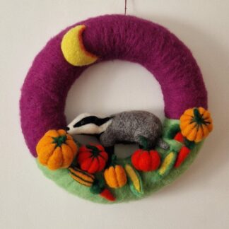 Unique felted autumn wreath with a badger amongst the pumpkins