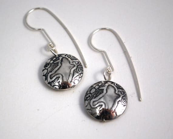 round silver bird earrings with a simple bird motif embossed on either side of the lentil shaped bead dropper.