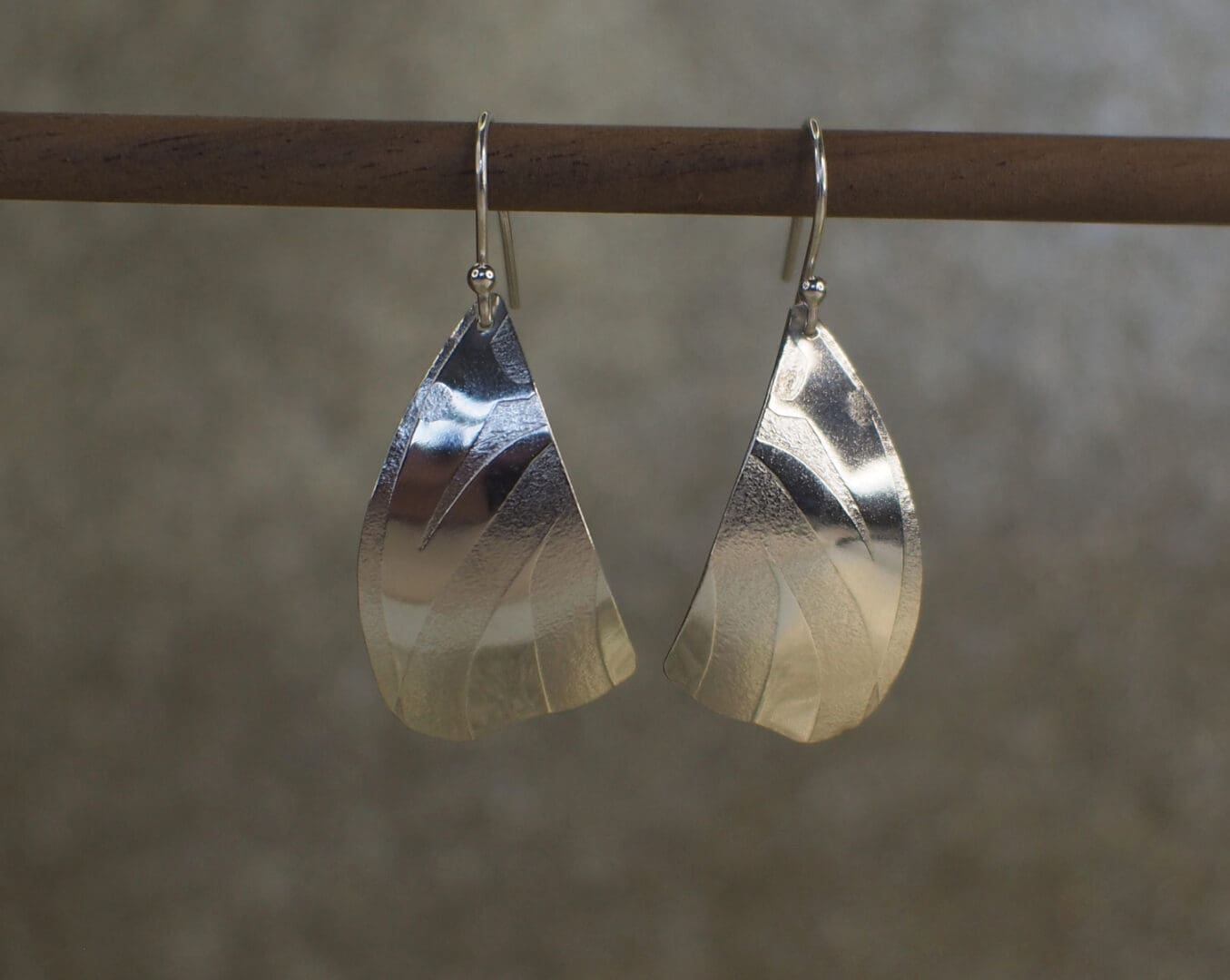 Sterling silver handmade butterfly drop earrings on stand