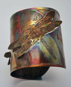copper dragonfly cuff on white background