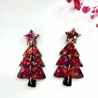 Sparkling resin Christmas tree earrings shown as handmade festive jewellery