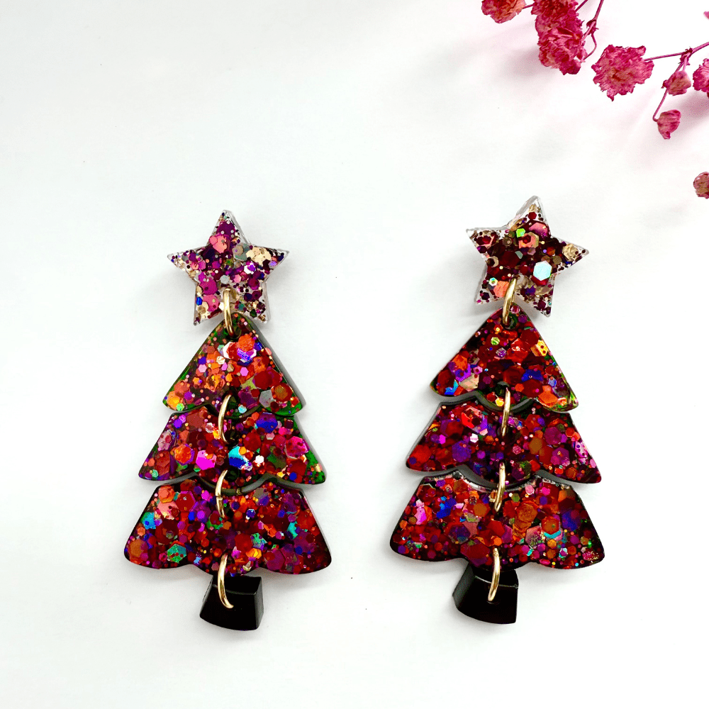 Sparkling resin Christmas tree earrings shown as handmade festive jewellery
