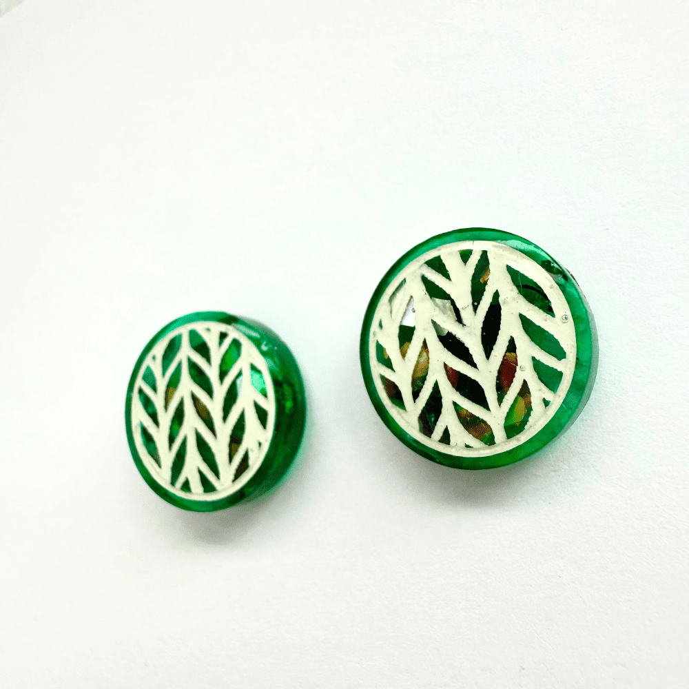 Right teal knitted-effect stud earring with holographic glitter background – detailed close-up view