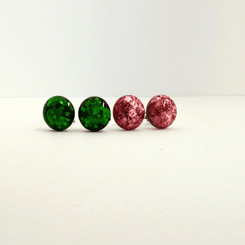 Resin stud earrings in witchy emerald green and playful pink glitter