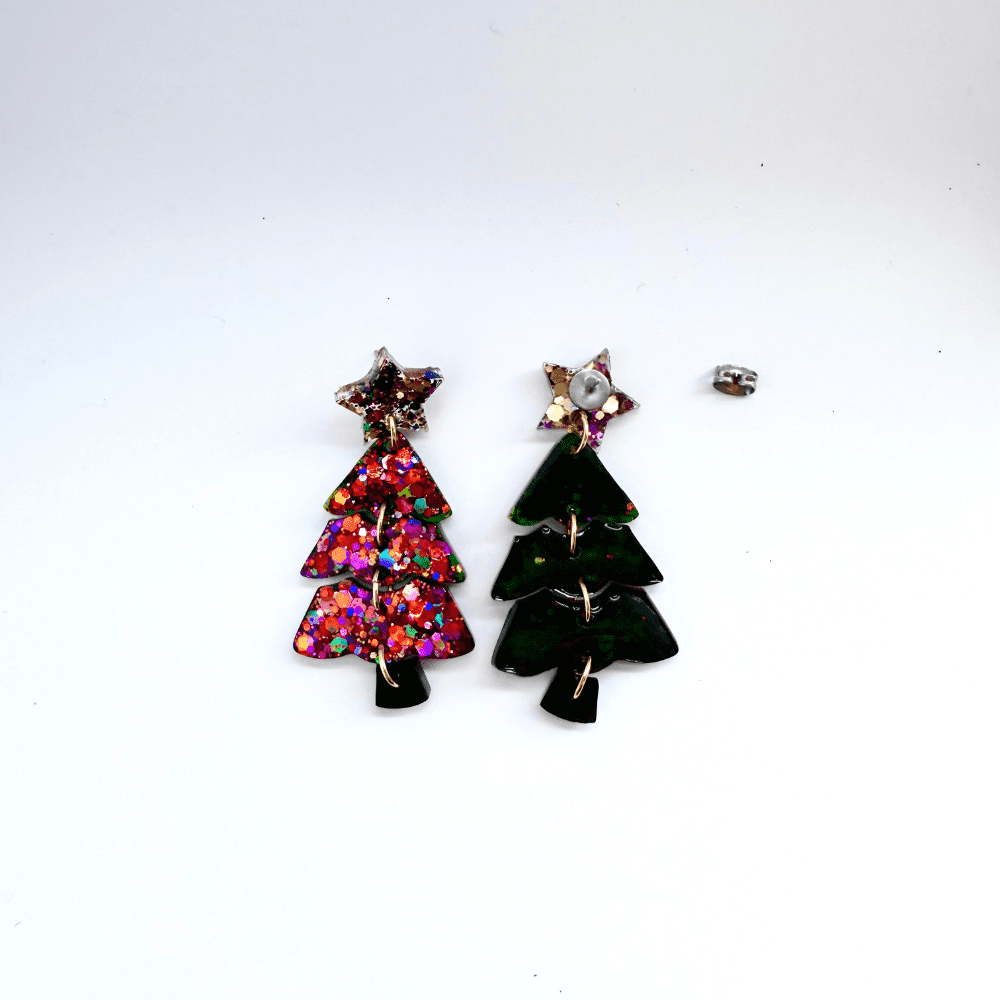 Handcrafted statement Christmas tree earrings for holiday parties showing the glittery front and green back.