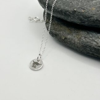laser engraved highland cow on a silver pendant