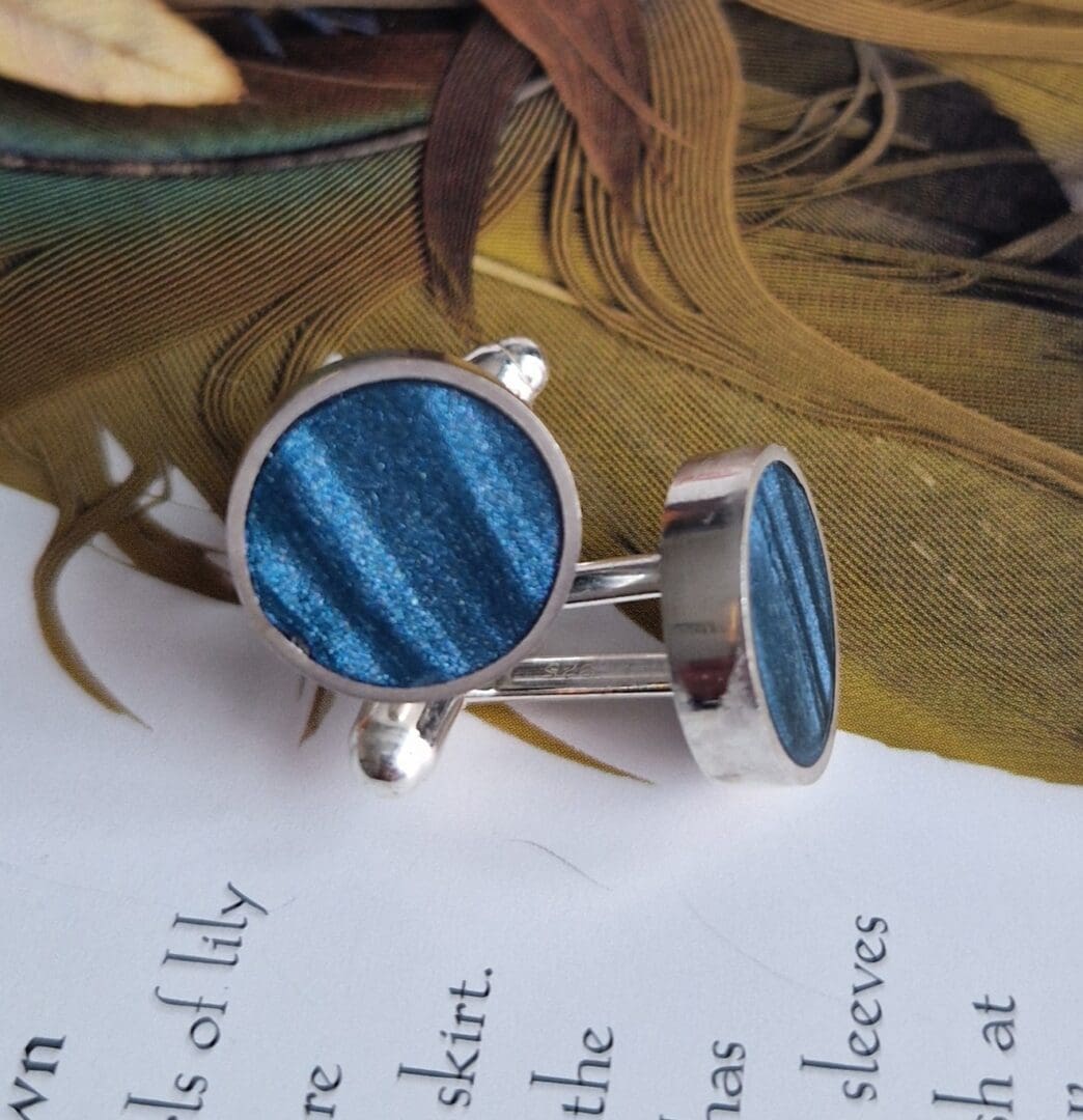 Handmade sterling silver round cufflinks, inlayed with polymer clay, in shades of petrol lyons blue with a satin finish