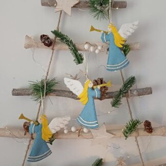 Angel with glitter trumpet felt Christmas tree hanging decorations by lyndawilcansew hung on a rustic winter tree branch