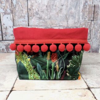 Red and black velvet storage tub with a pom pom trim