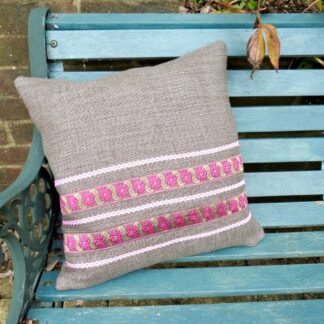 Handmade brown hopsack cushion with a pink ribbon trim