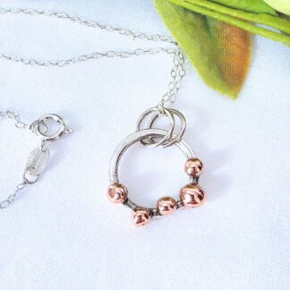 Silver ring with copper beads pendant necklace.