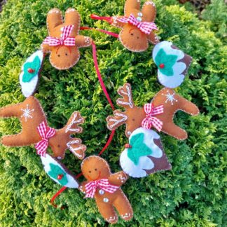 a-handmade-felt-Christmas-garland. Made-up-of-reindeer-gingerbread-men-and-christmas-pudding-hearts