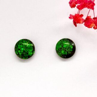 Wicked glittery green and black accented dress studs on a branded Copper Magpie Designs card. Hypoallergenic surgical steel jewellery.