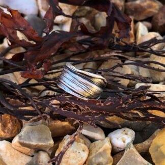 Close-up of textured silver ring showing seaweed-inspired striations