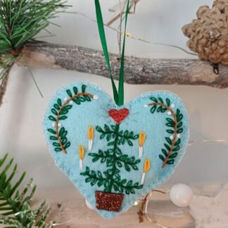 Scandi candle tree heart felt Christmas tree hanging decoration by lyndawilcansew hanging on a rustic winter tree branch