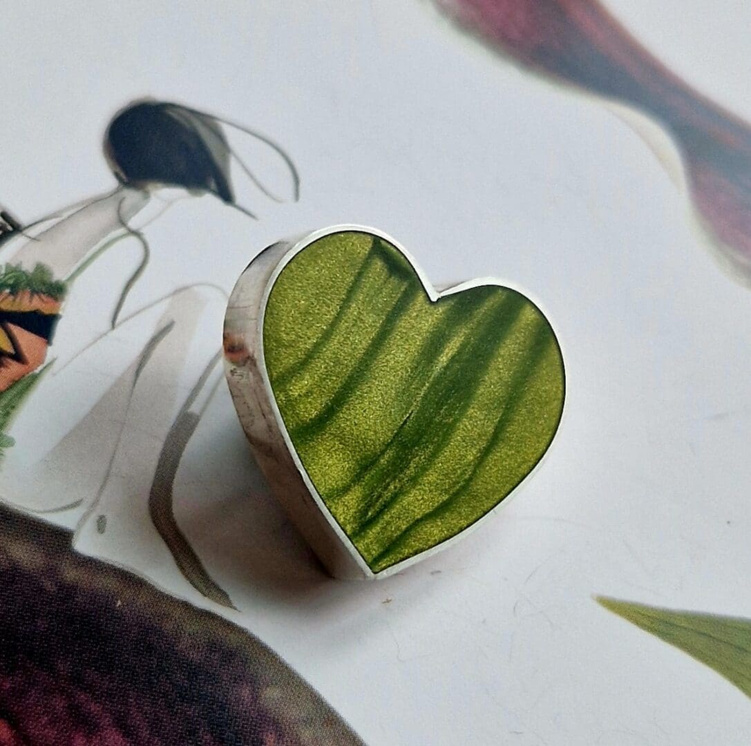 Handmade sterling silver heart brooch, inlayed with polymer clay, in shades of whitegrape golden green with a satin finish