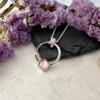 Pink and green tourmaline gemstone set in a silver circle necklace
