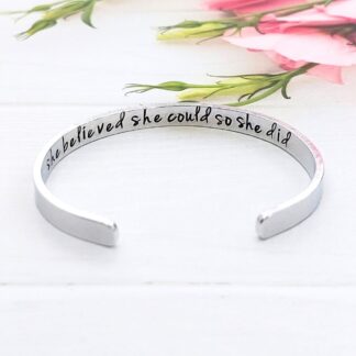 A 6mm width aluminium adjustable cuff bracelet with the words 'she believed she could so she did' hand-stamped inside