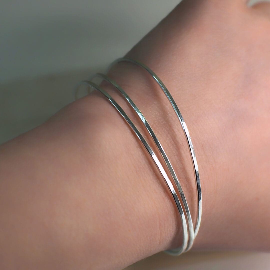 silver bangles on a female wrist