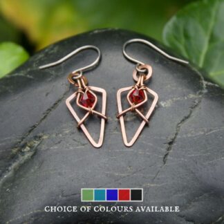 Small copper arrowhead shaped earrings with red glass beads by Oruki Design