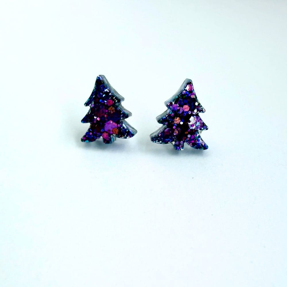 Sparkly purple resin earrings shaped like Christmas trees, handmade design.