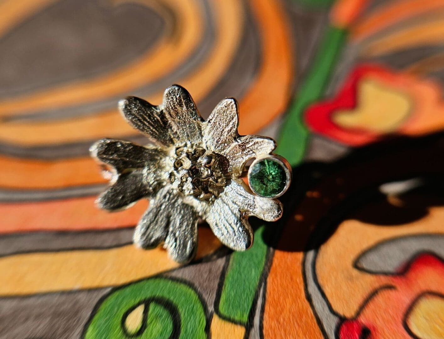 Sterling silver, tsavorite garnet hand carved flower earring, shot on hand drawn BG, Isobel Kelly Jewellery