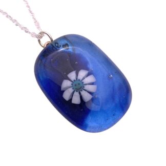 Blue rectangular glass pendant with a smiling white flower encased inside. Clear glossy finish with a silver chain, conveying a playful and cheerful vibe.