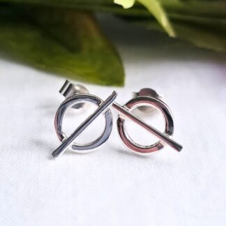 Silver stud earrings featuring a circular ring with a bar across its centre.